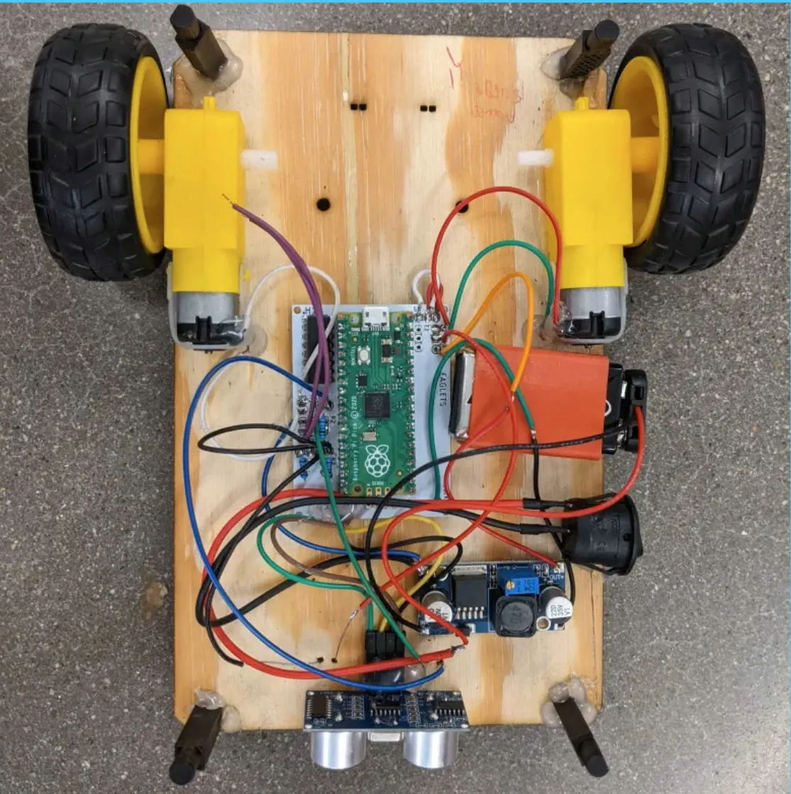 Top view of the second Eaglets robot kit, showing motors, controller, wiring, and sensor.